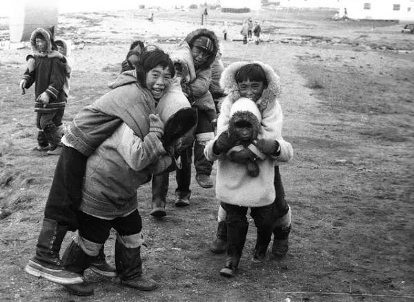 A Large Group Of Children Playing Outdoors