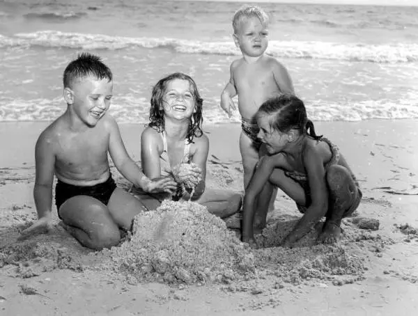 Children Playing In The Sand At Beach