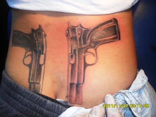 lower back pistol tattoos