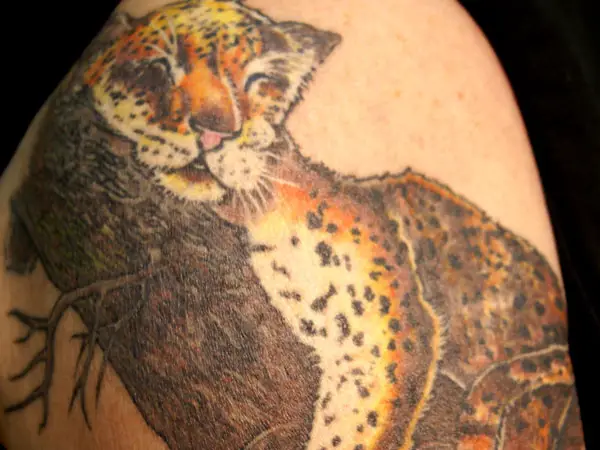 snow leopard tattoo arm