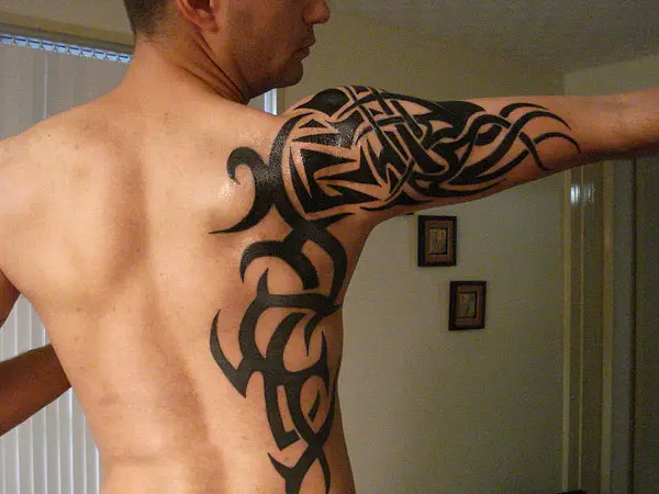 tribal shoulder tattoo with cross