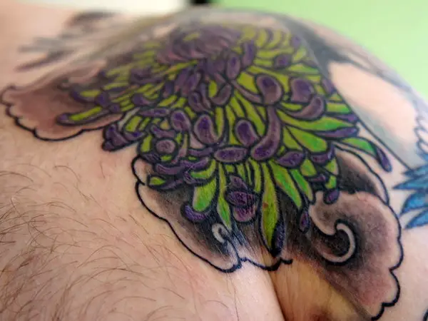 New school shoulder tattoo of a chrysanthemum