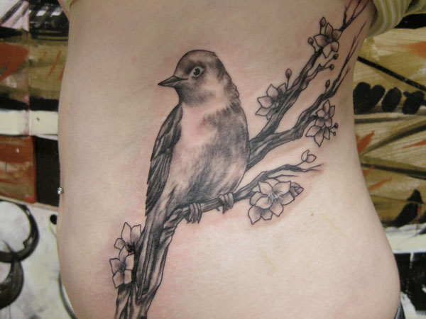 Nightingale Sitting On A Branch Tattoo