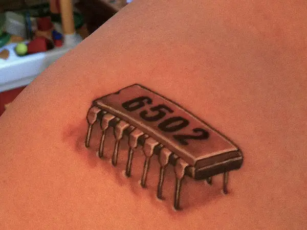 Shoulder chip number tattoo