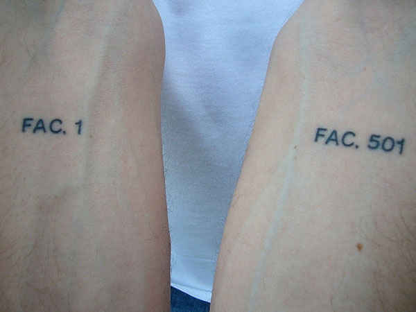Plain forearm tattoo with number sequence