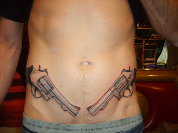 lower stomach gun tattoos