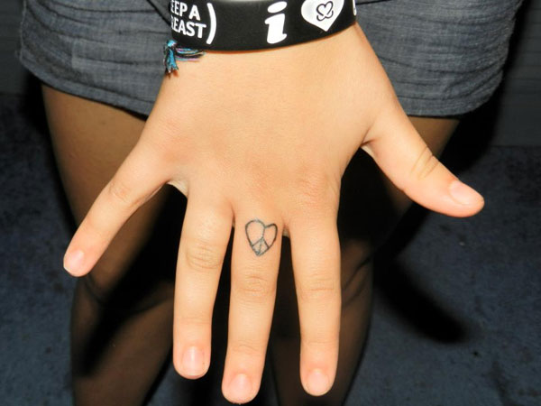 Miley Cyrus Peace Tattoo Meaning and Story Behind the Peace Sign Tat