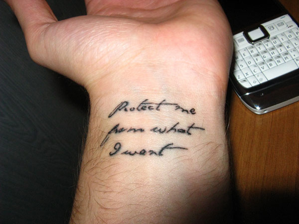 Wrist Flowy Script Tattoo