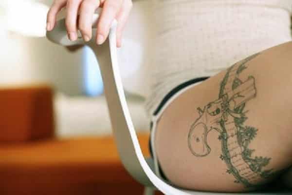 gun tattoos on hips for women