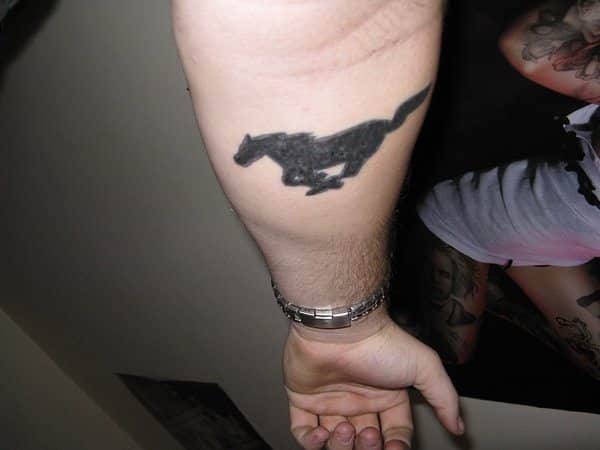 Solid Black Mustang Arm Tattoo