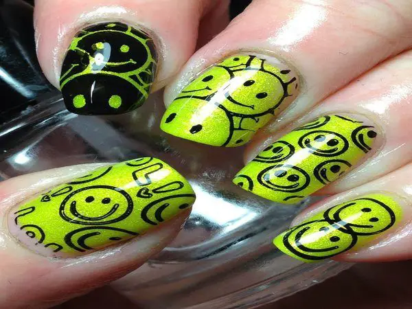 Yellow Glitter Smiley Face Nails with One Black Smiley Face Nail