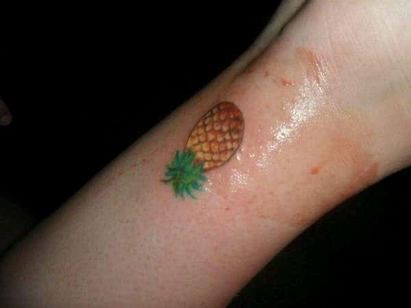 Small Colored Pineapple Inner Wrist Tattoo