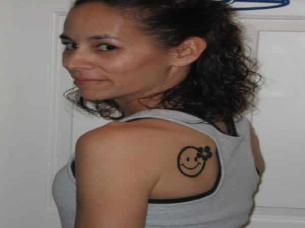 Girl Smiley Face Tattoo with Flower On Back of Shoulder