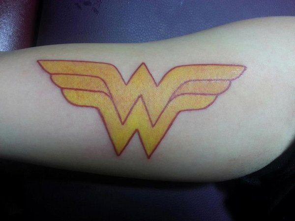 Yellow and Red Colored Wonder Woman Symbol Arm Tattoo