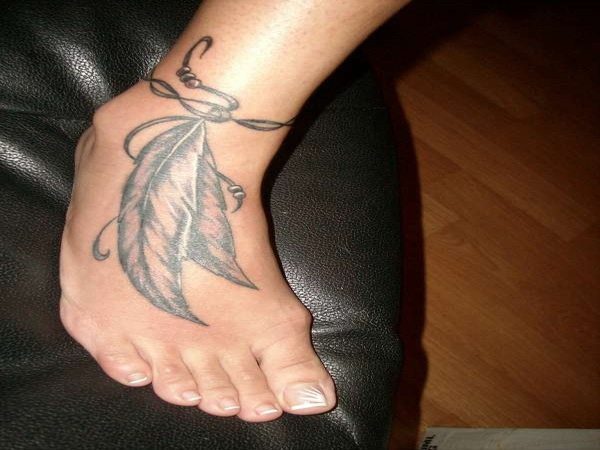 Black Ink Ankle Tattoo with Leather Strings, Beads,and Long Feathers