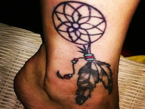 Ankle Tattoo of Dream Catcher with Long Feathers and Red and Green Beads