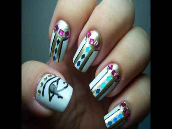 White Nails with Egyptian Design, Yellow Rhinestones, and Pink Rhinestones