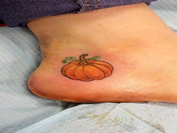 Tiny Pumpkin Heel Tattoo