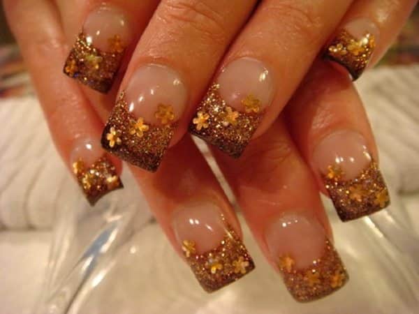 Plain Nails with Brown Tips and Orange Flowers and Glitter Decorations