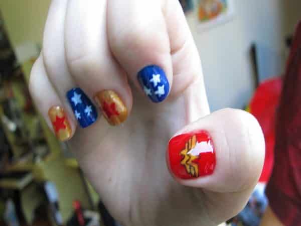 Blue and Gold Nails with Red Thumb Nail and Star Decorations