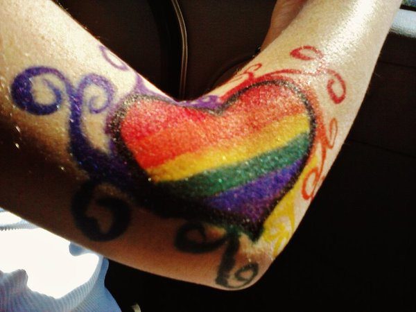 Rainbow Heart Arm Tattoo with Multicolored Swirls