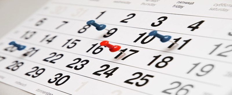 Closeup calendar page with drawing-pins Closeup calendar page with drawing-pins