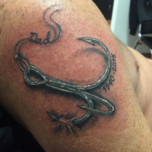 Line art fish hook tattoo on the thigh