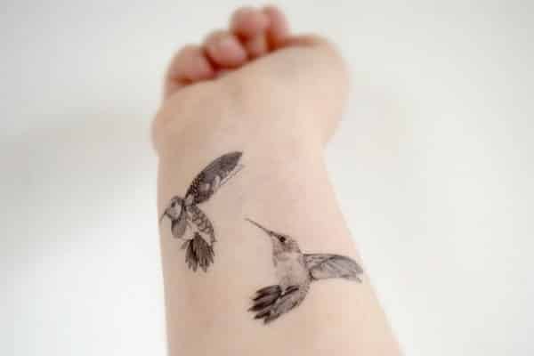 Humming birds hand tattoos for women