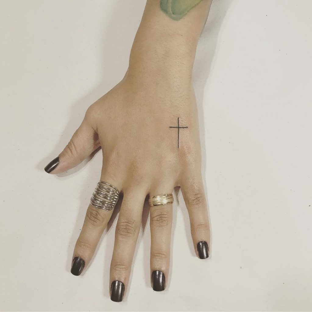 Minimalistic Cross hand tattoos for women